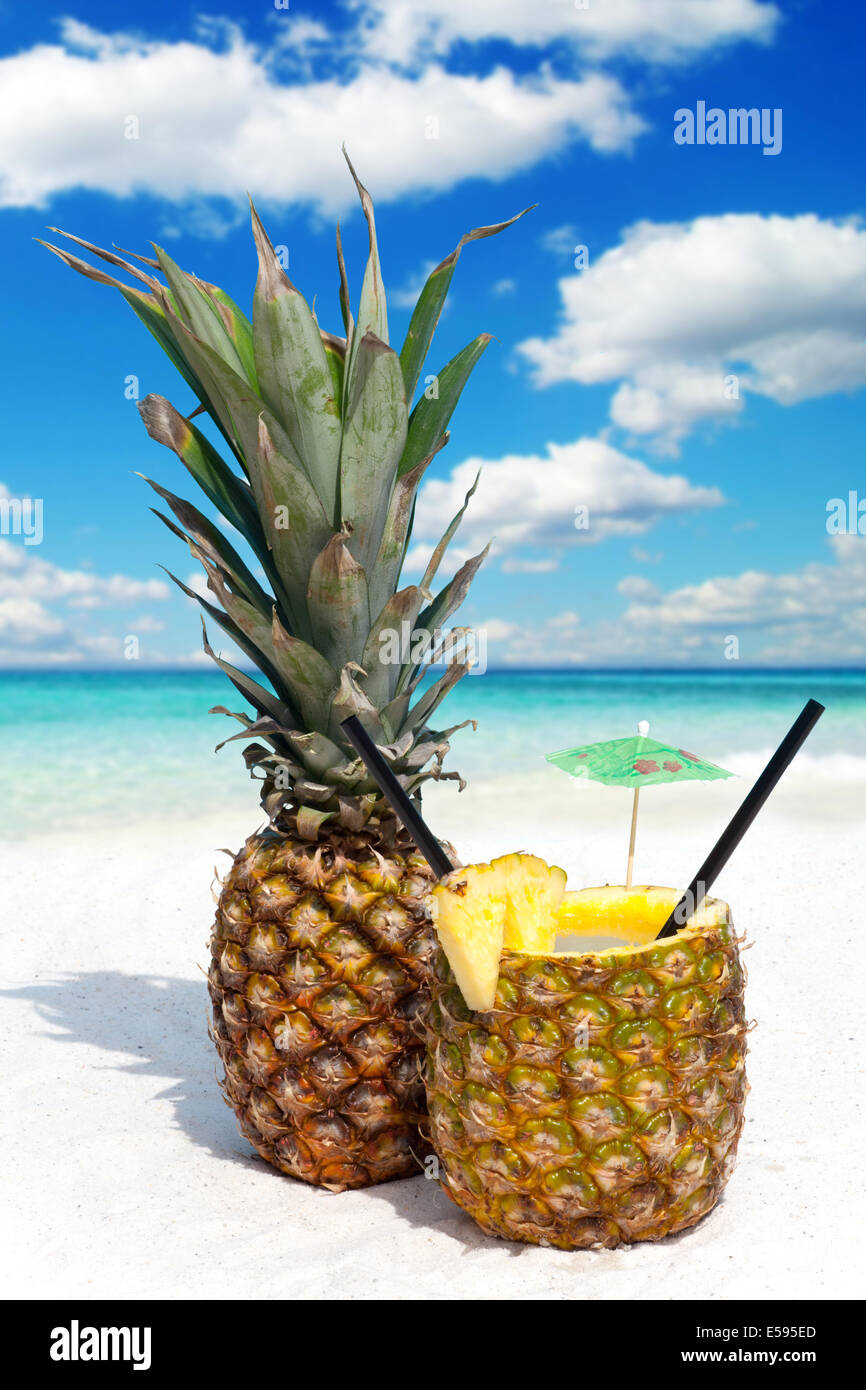 Pineapple fruit and a cocktail on the sandy tropical beach Stock Photo ...
