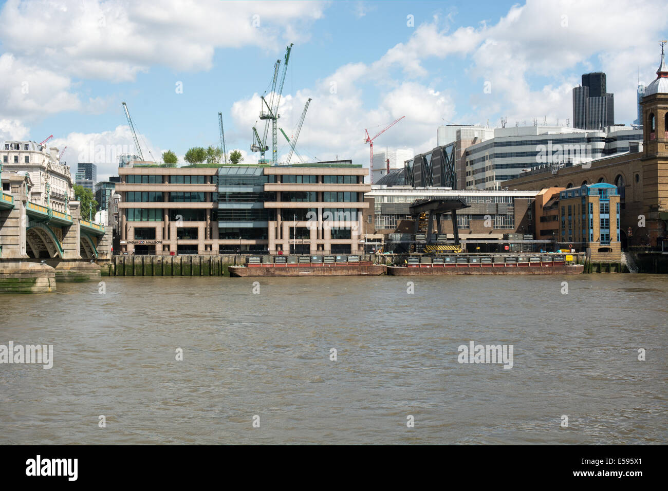 Barges are moored on the North side of the Thames ready to receive some of London's waste and transport it down river Stock Photo
