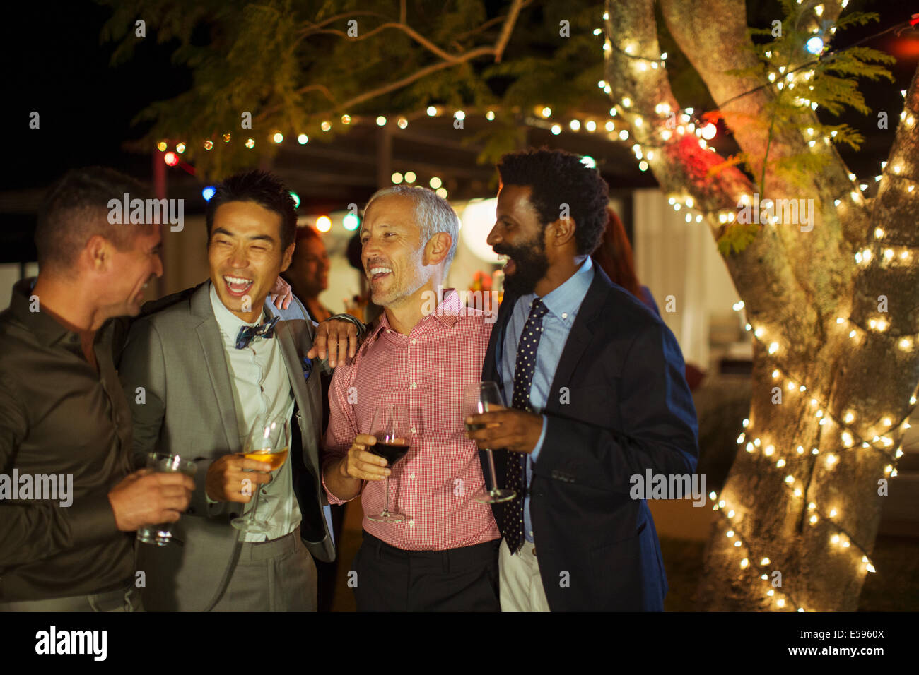 Men talking at party Stock Photo