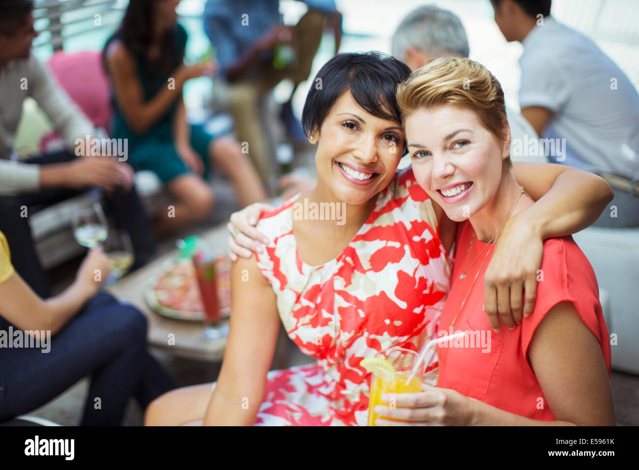 Women hugging at party Stock Photo