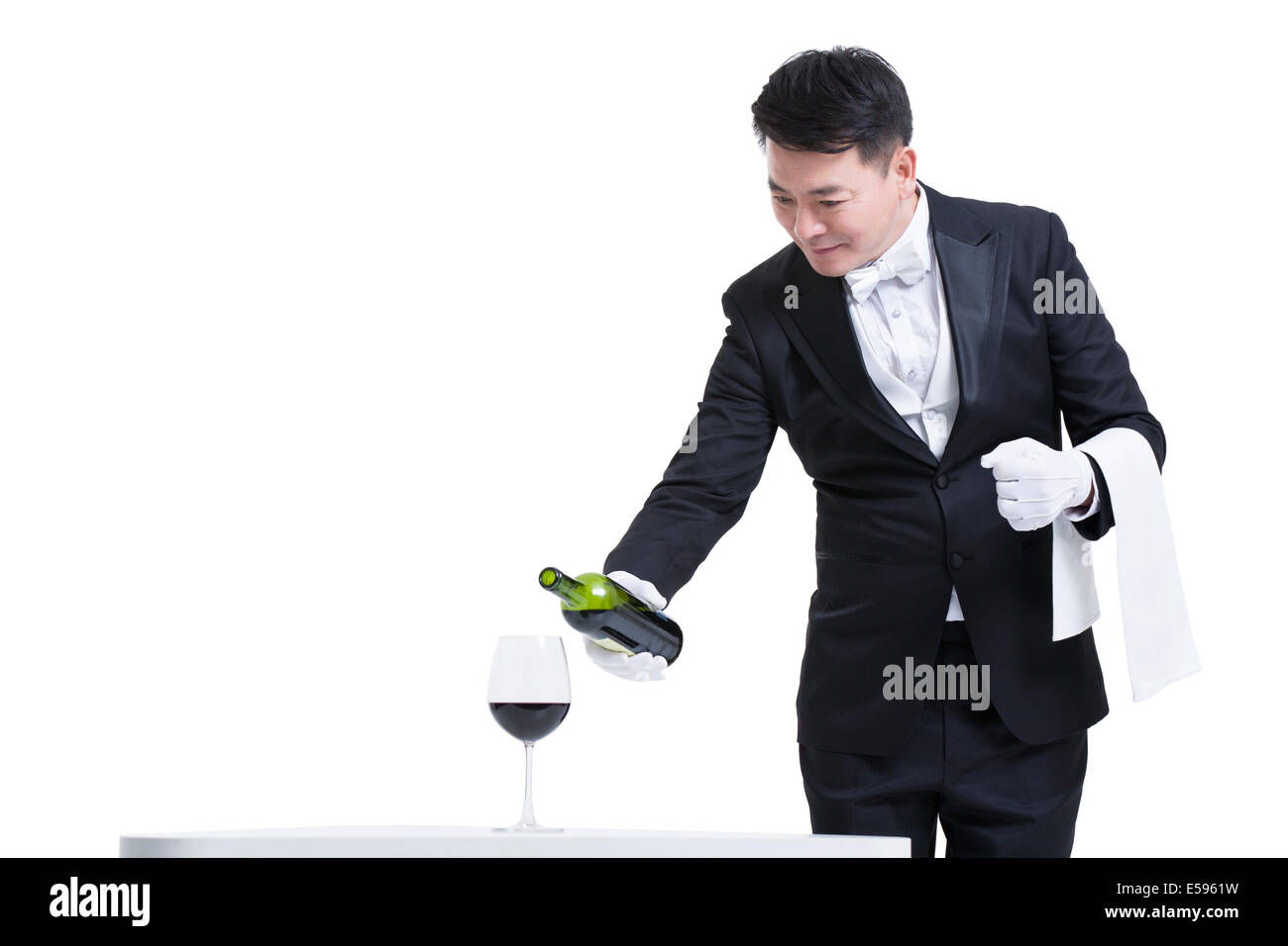 Waiter pouring wine Stock Photo Alamy