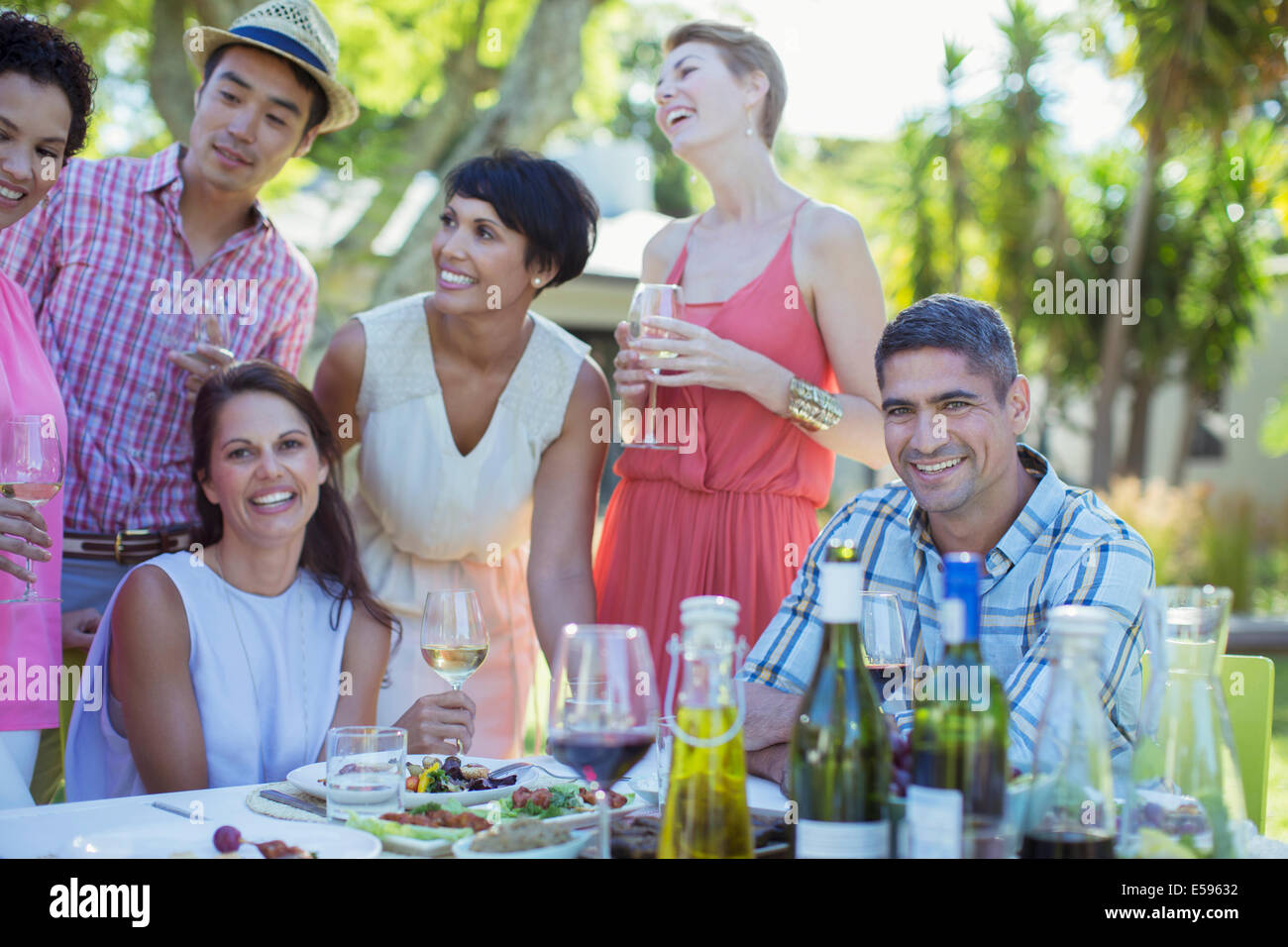 Friends relaxing at table outdoors Stock Photo