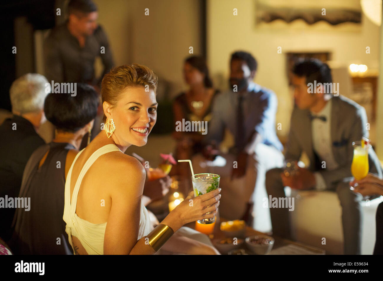 Woman smiling at party Stock Photo