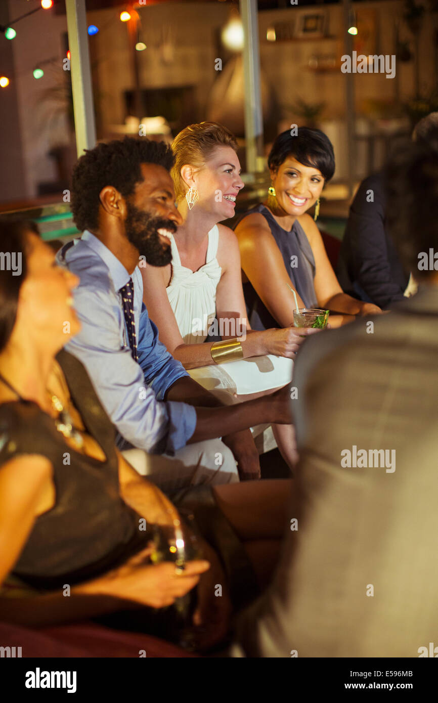 Friends relaxing at party Stock Photo