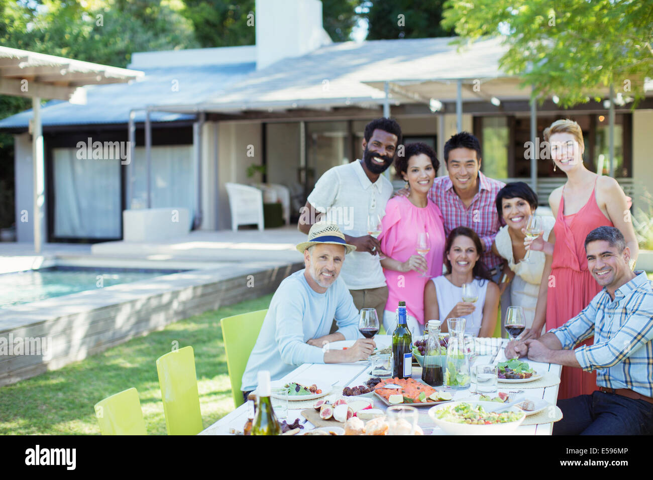 Friends smiling together at party Stock Photo