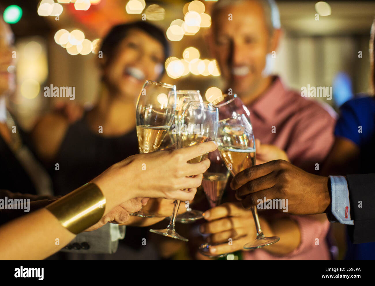 Friends toasting each other at party Stock Photo