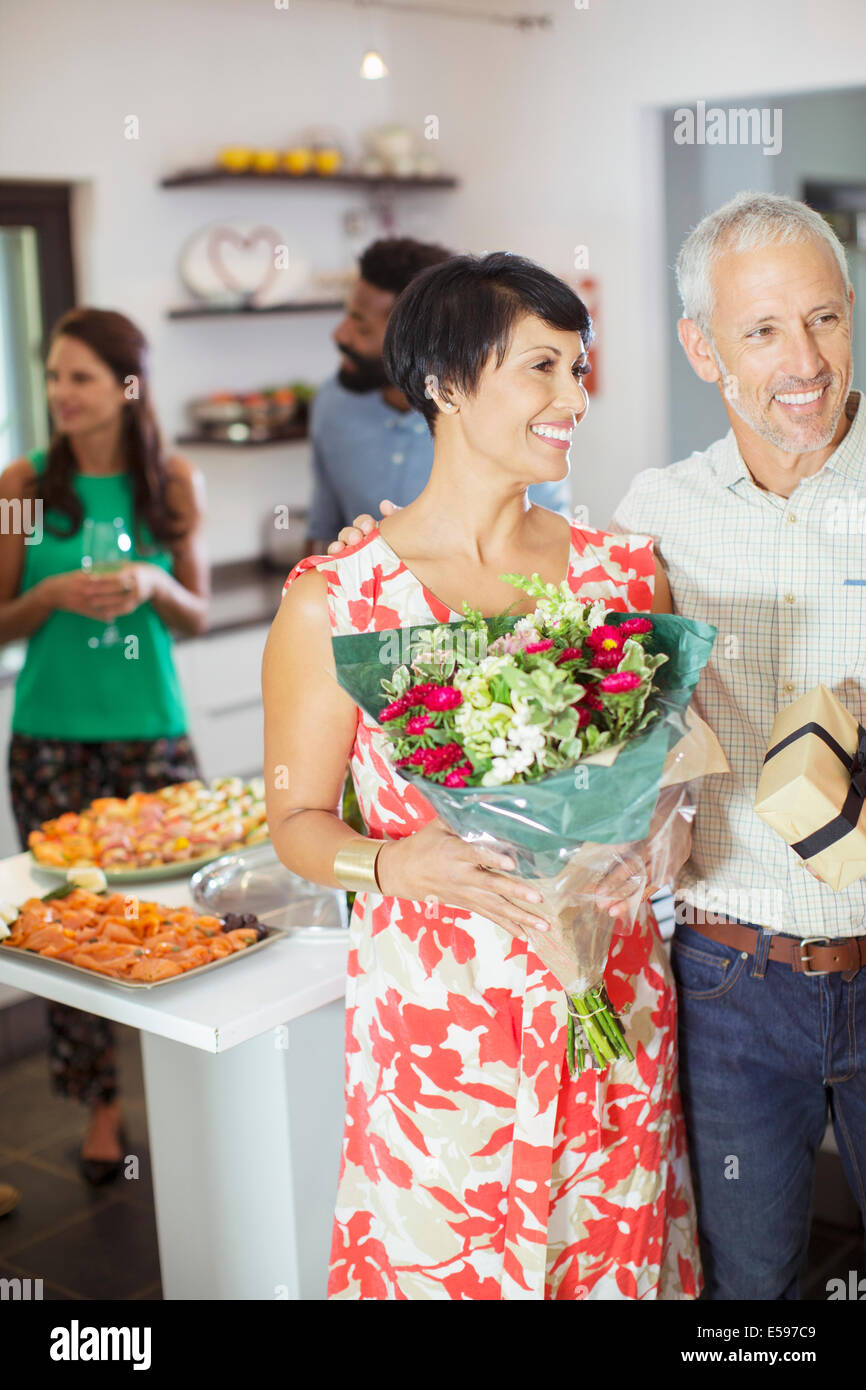 Couple carrying gifts at party Stock Photo
