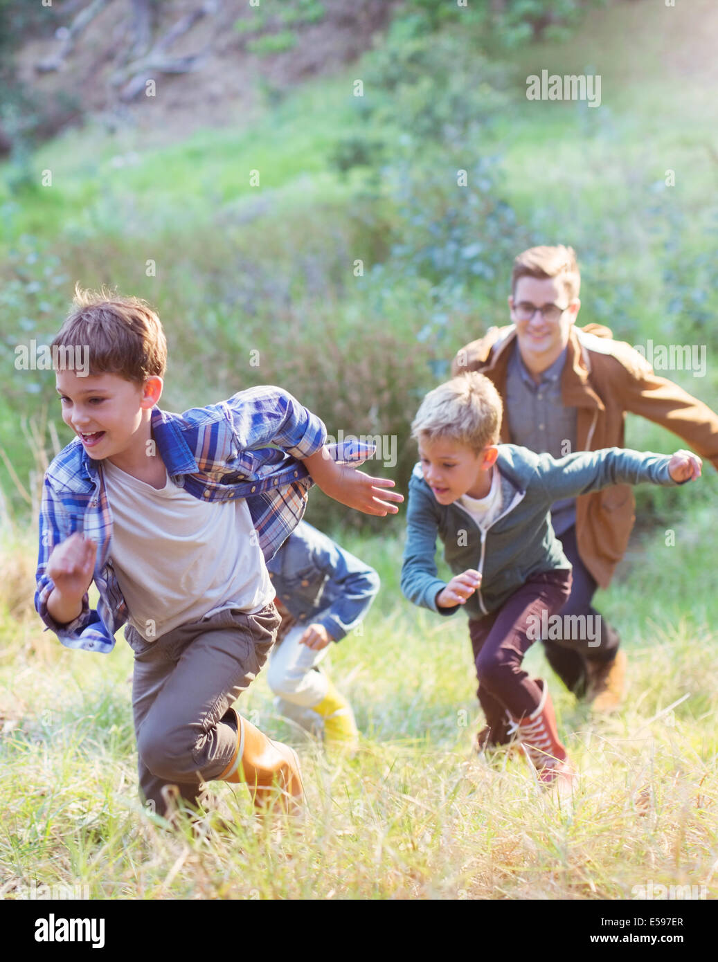Boys running in field Stock Photo