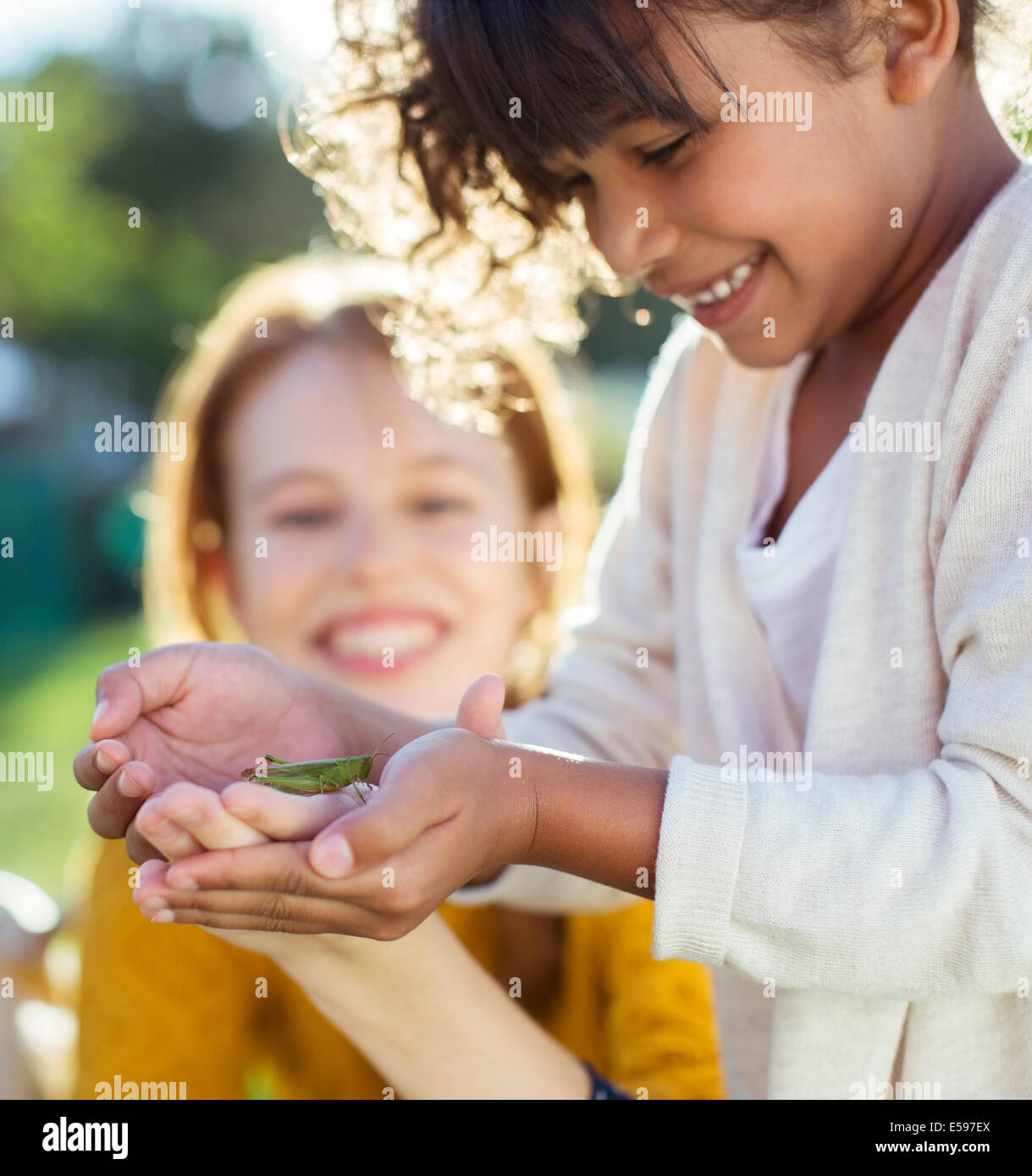 Mother and daughter examining insect Stock Photo