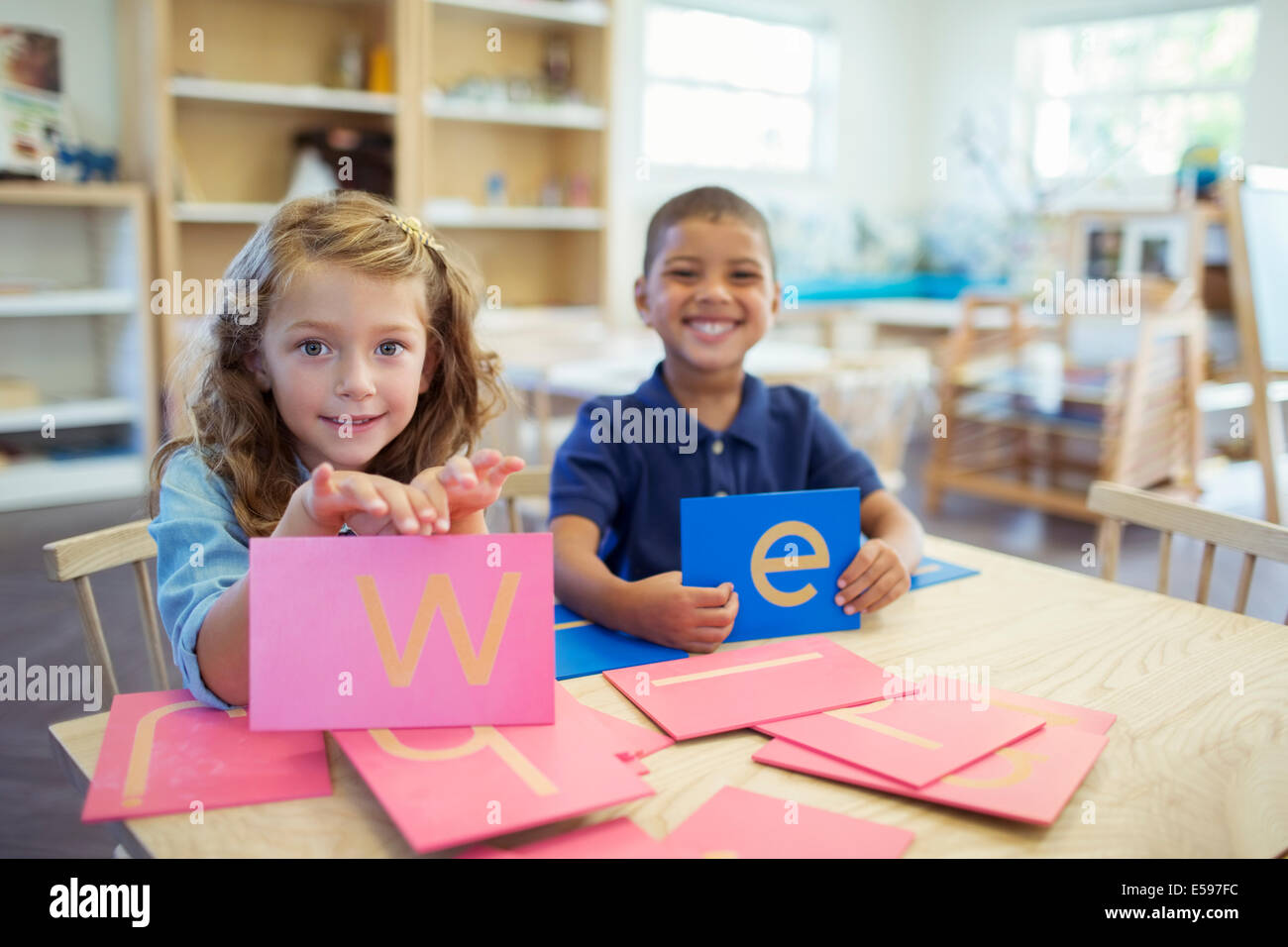 Students holding letters in classroom Stock Photo
