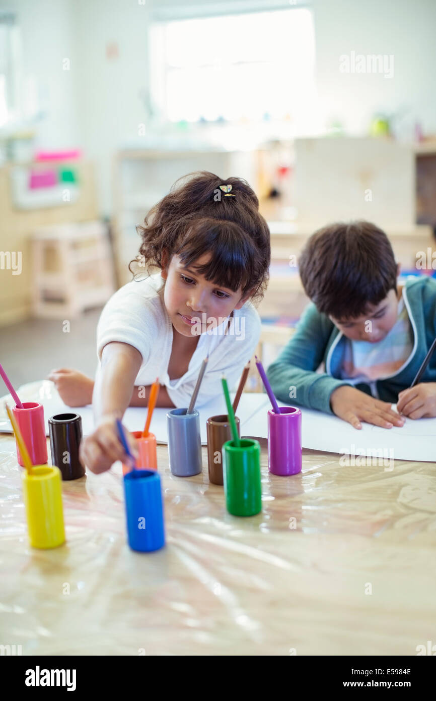 Students painting in classroom Stock Photo