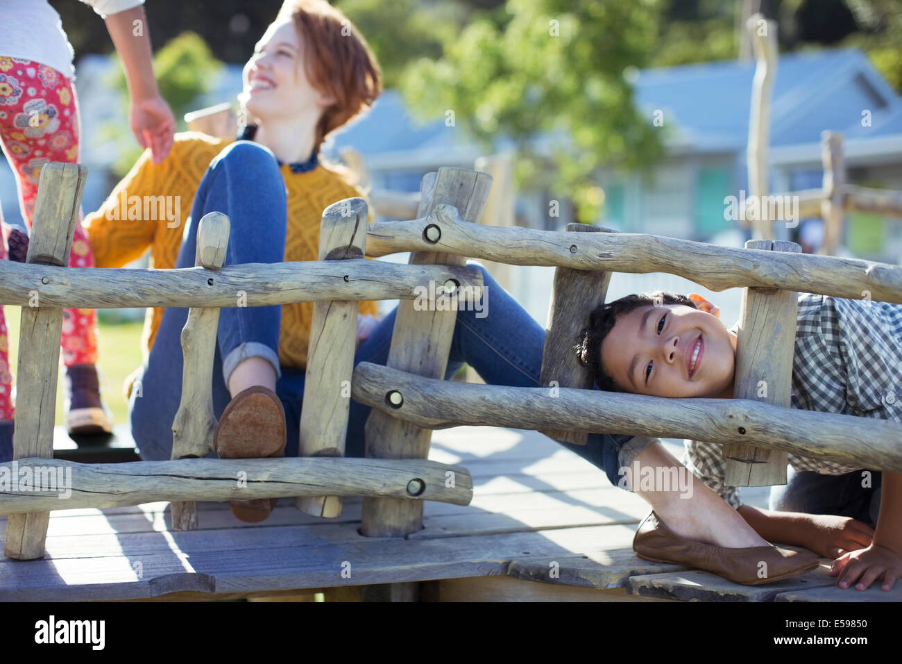Teacher and students playing on play structure Stock Photo