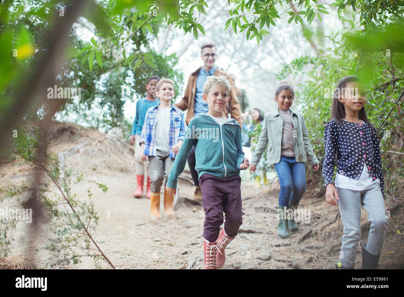 Students and teacher walking in forest Stock Photo