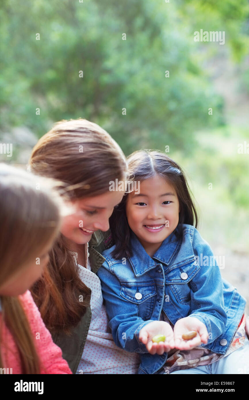 Teacher and student examining plants outdoors Stock Photo