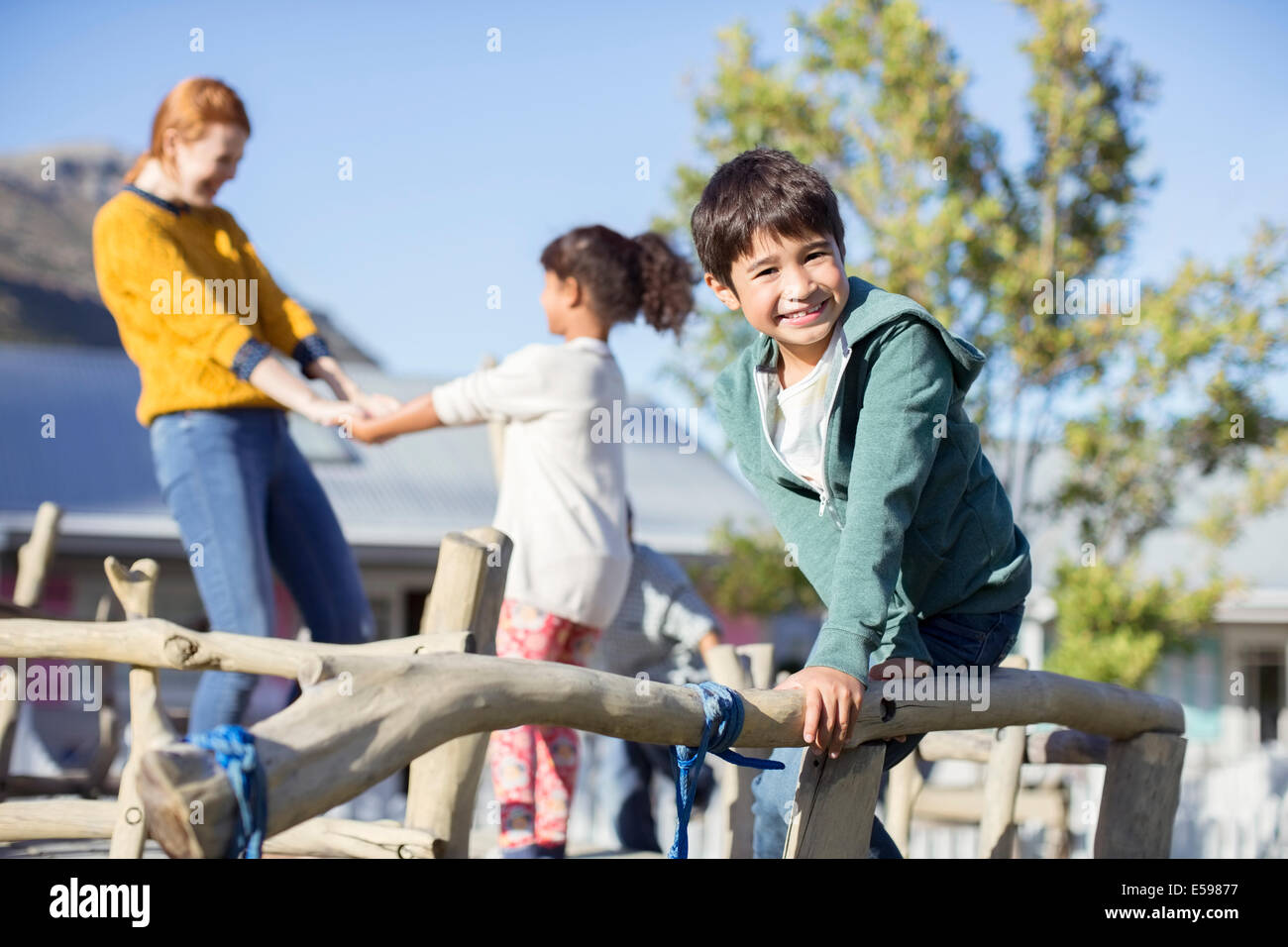 Teacher and students playing outdoors Stock Photo