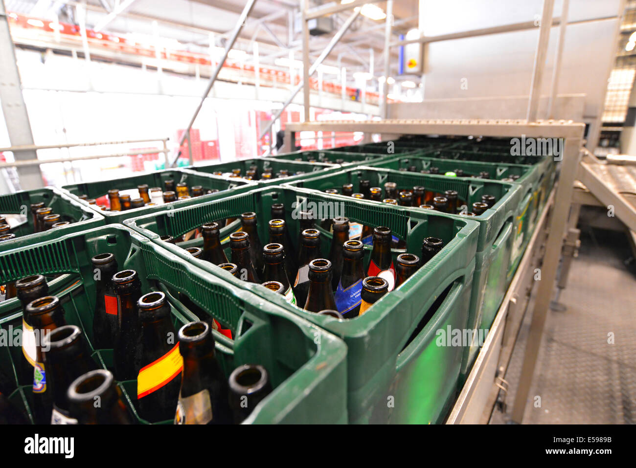 Germany, beer crates with empty bottles on an assembly line of a brewery Stock Photo