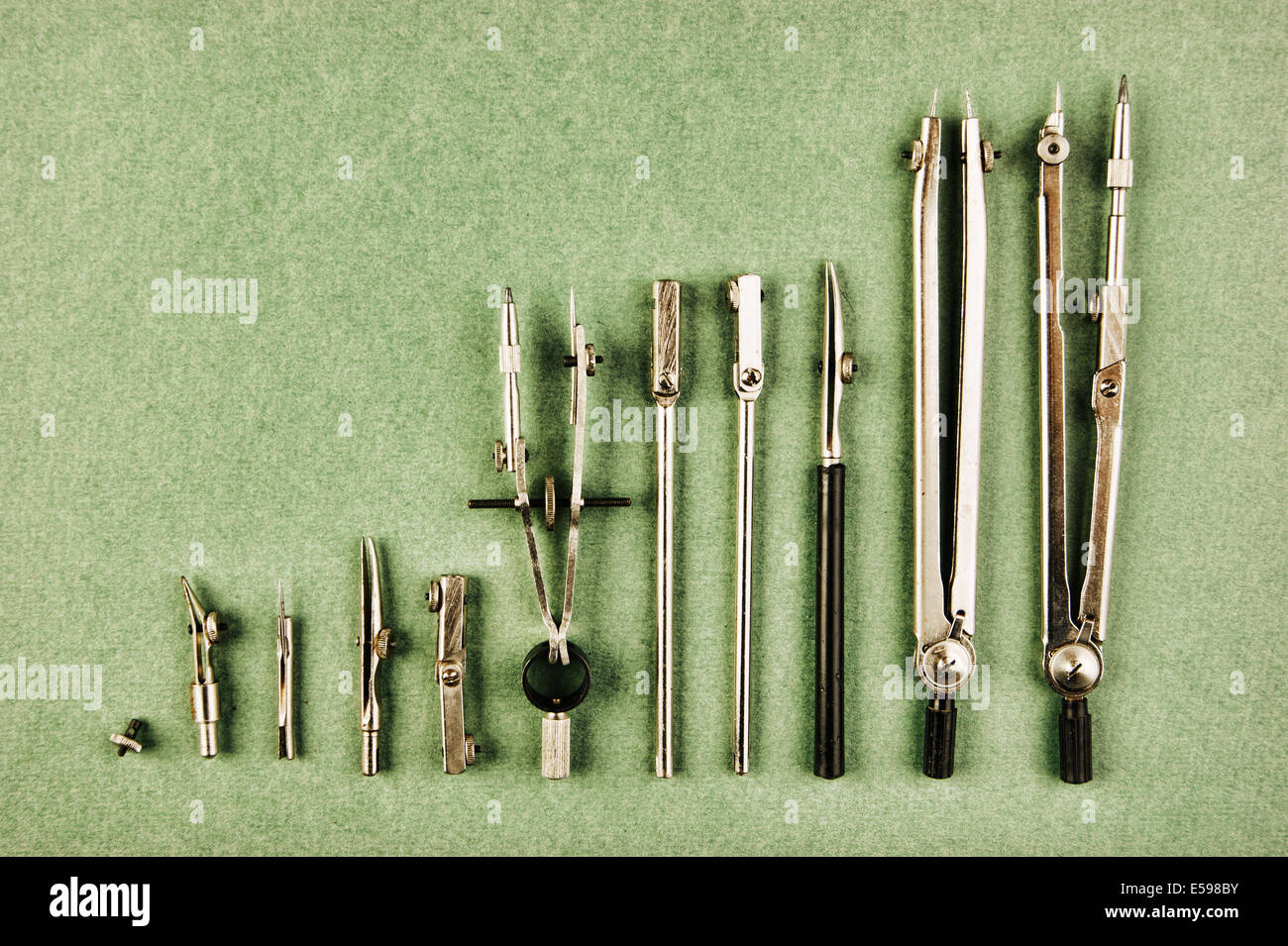 Old drawing tools on a green background Stock Photo