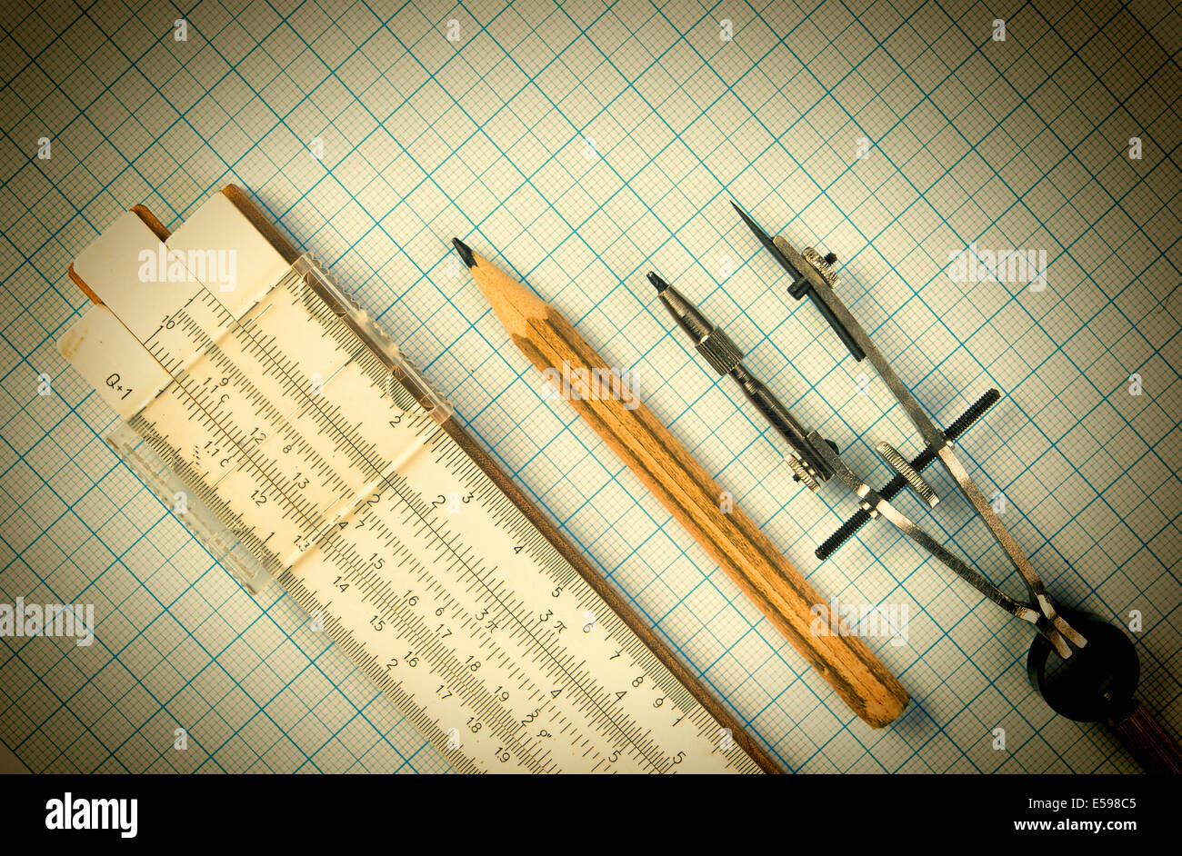 Old drawing tools on graph paper Stock Photo