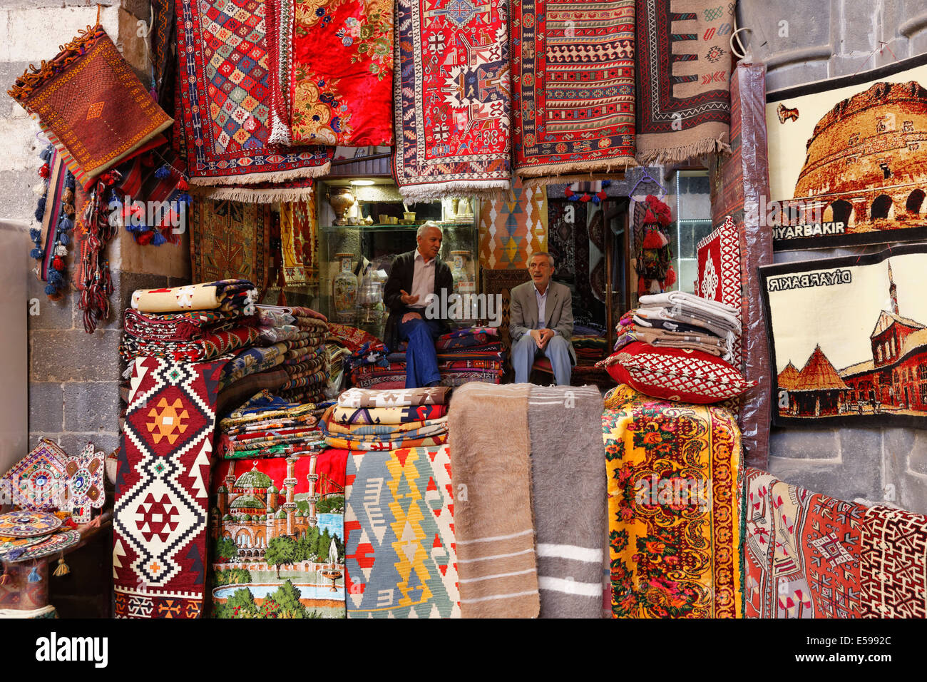Turkey, Diyarbakir, Hasan Pasa Hani, two men sitting in carpet shop