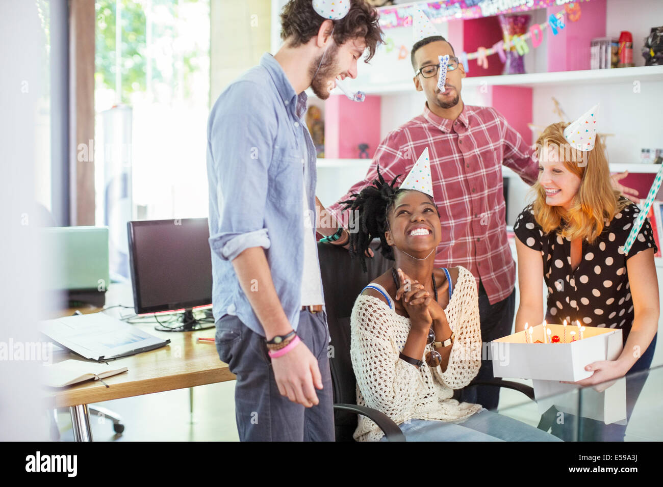 People celebrating birthday in office Stock Photo