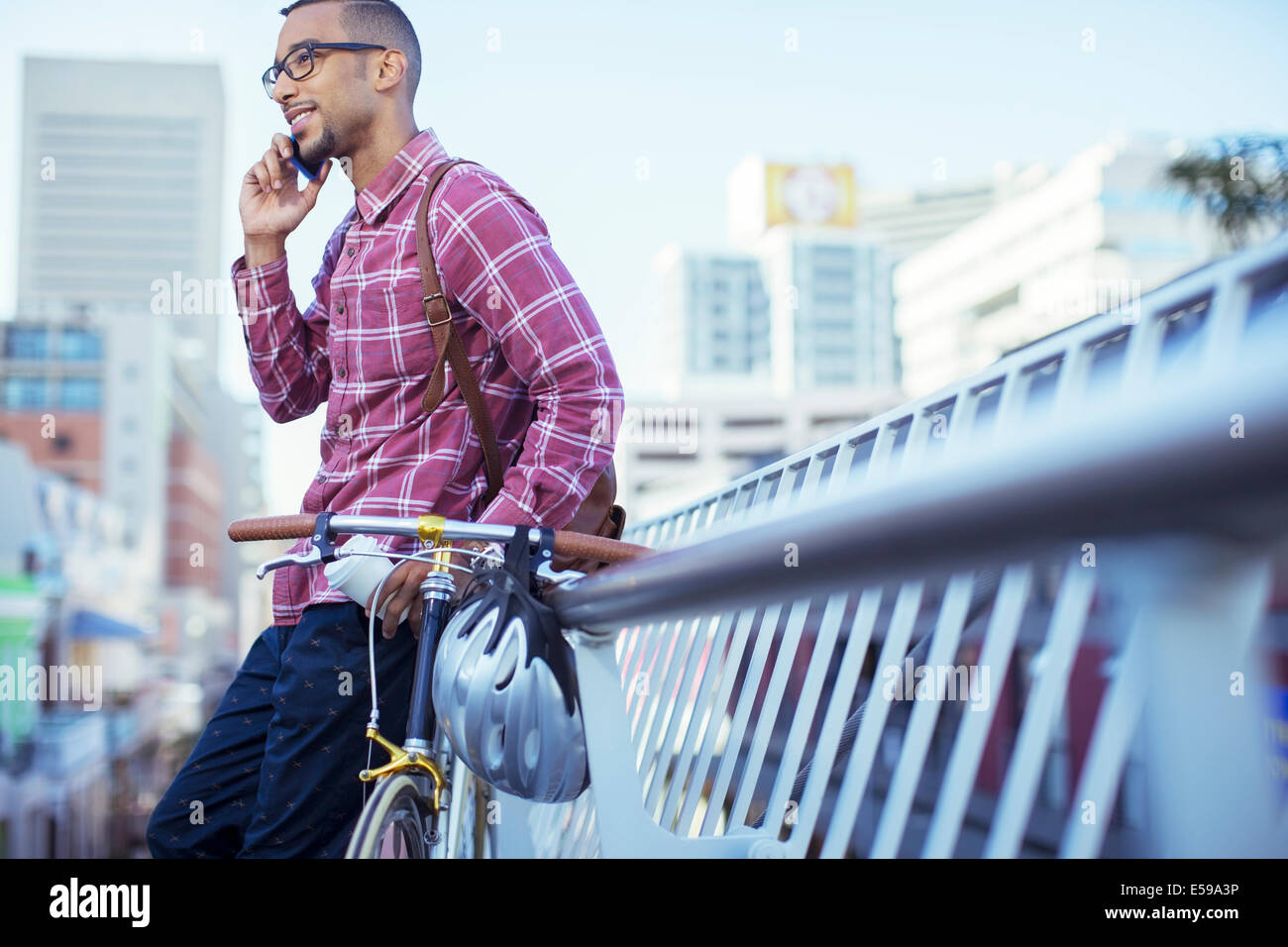 Man talking on cell phone on city street Stock Photo