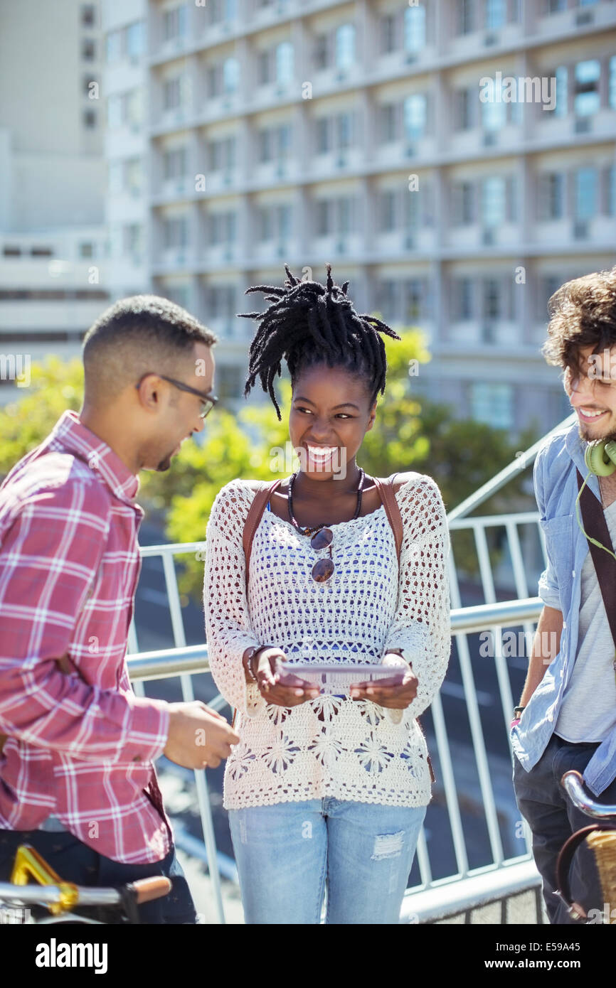 Friends talking on city street Stock Photo