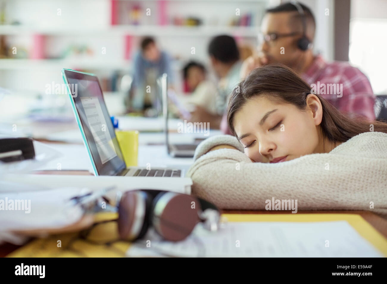 Woman sleeping at conference table Stock Photo