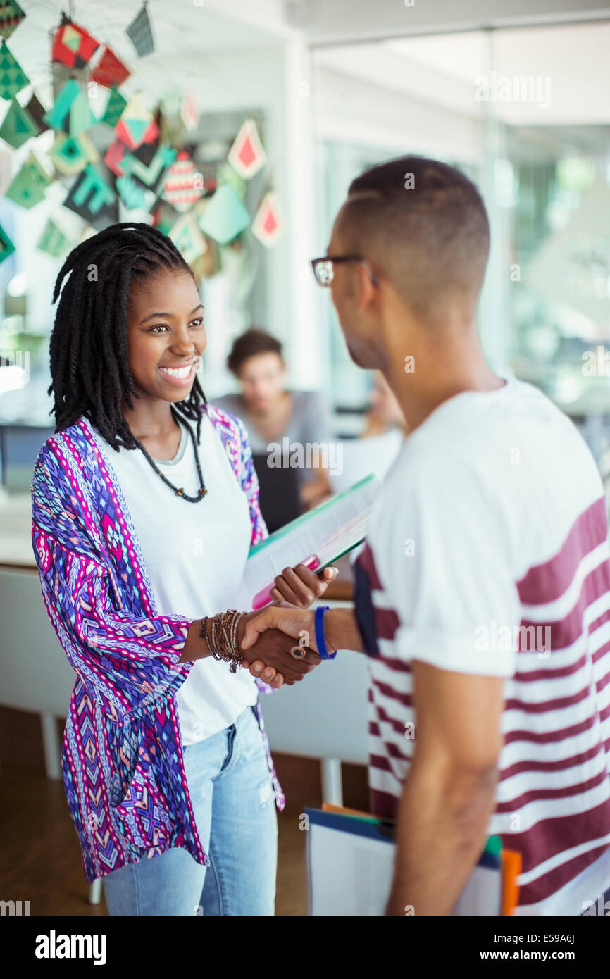 People shaking hands in office Stock Photo