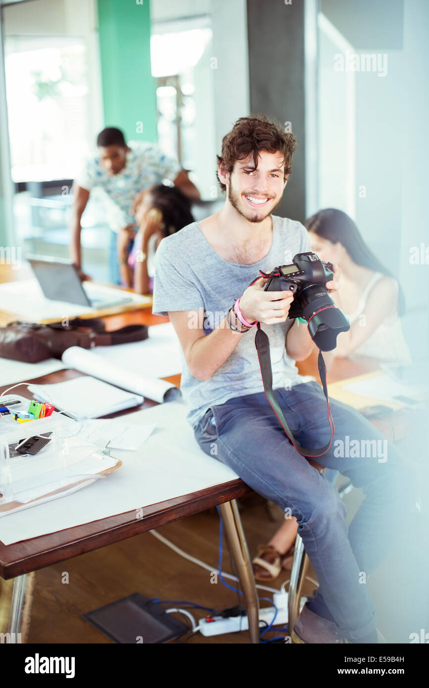 Man reviewing photos in office Stock Photo