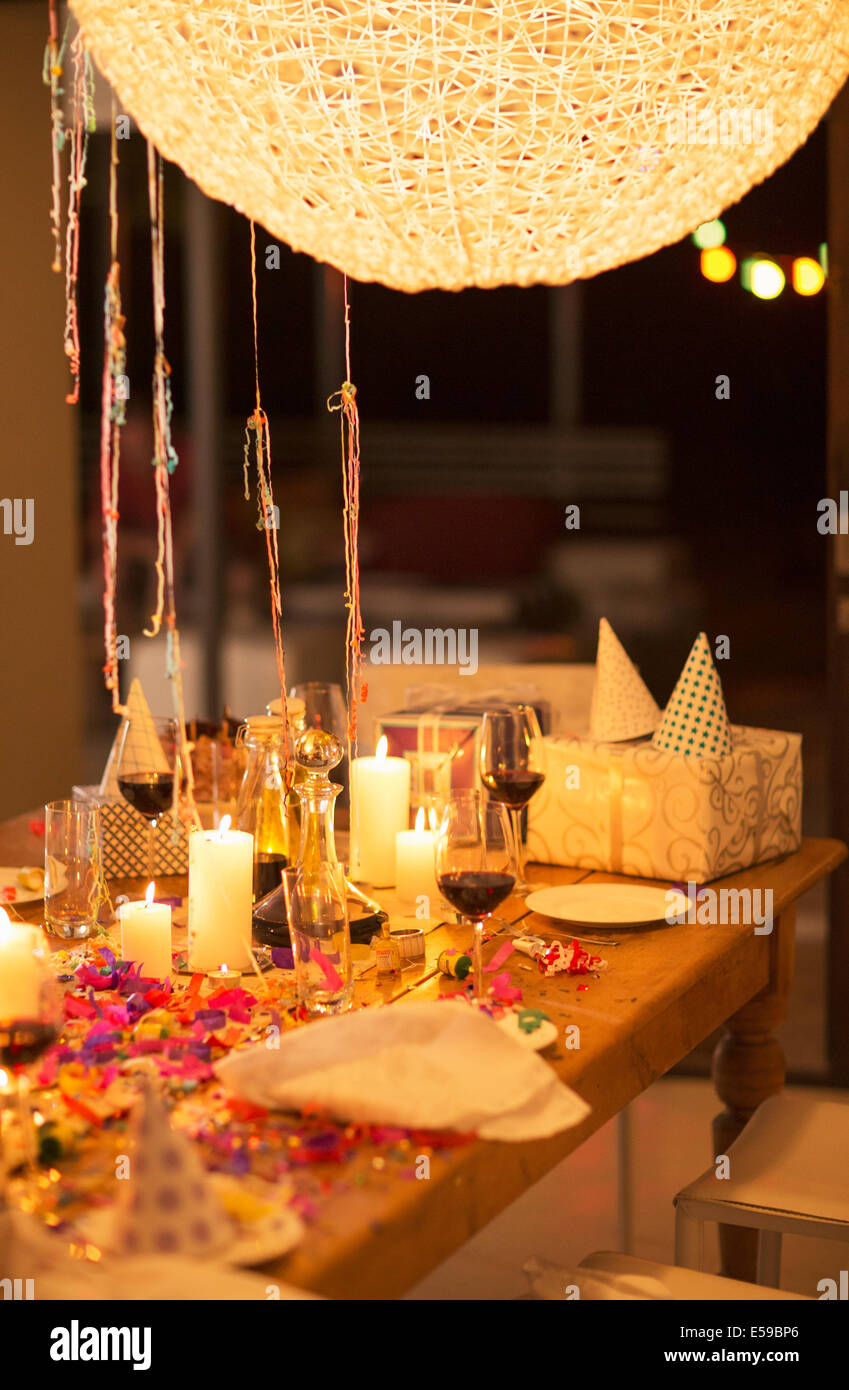 Candles and gifts on table at birthday party Stock Photo
