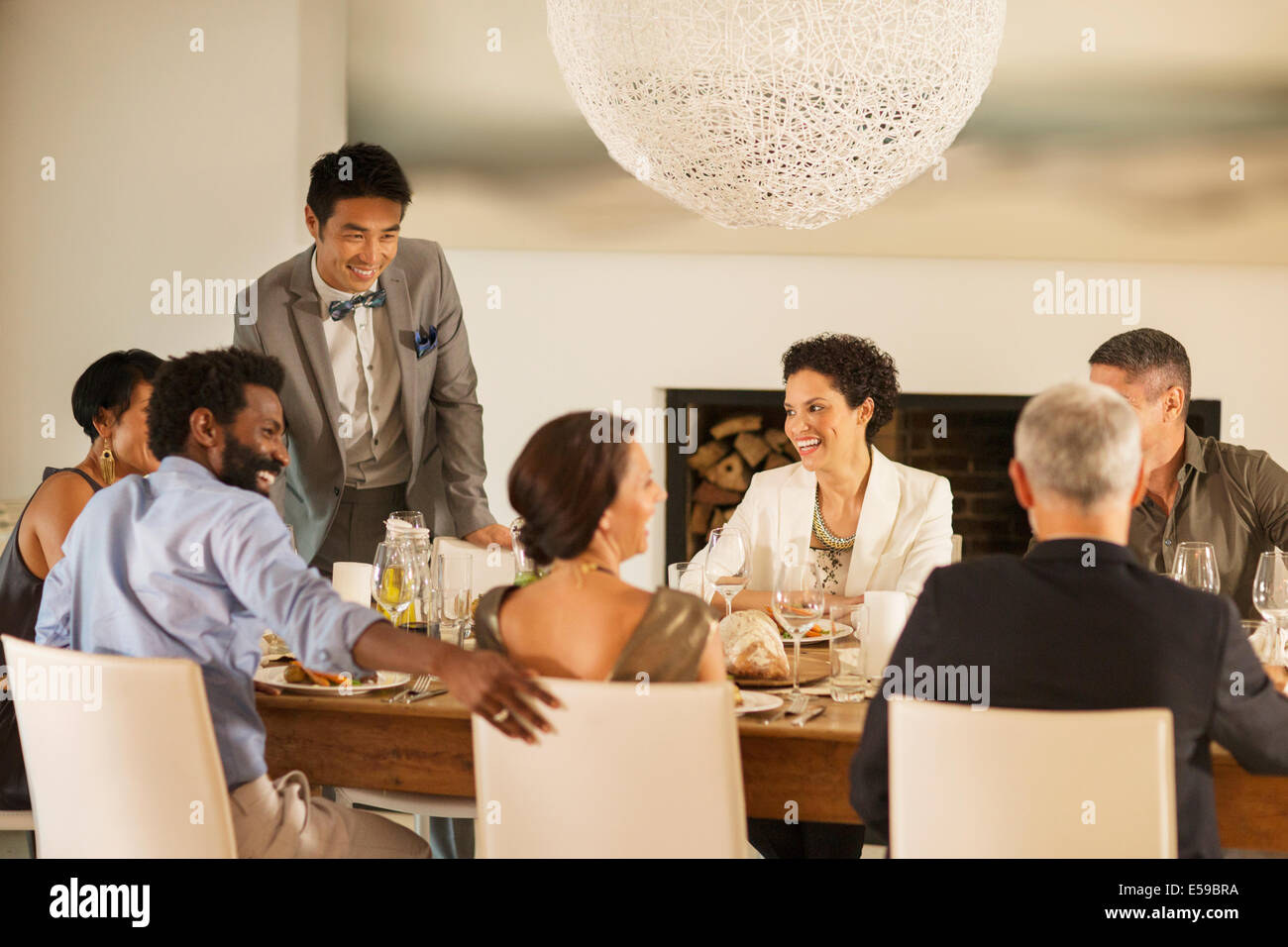 Friends talking at dinner party Stock Photo