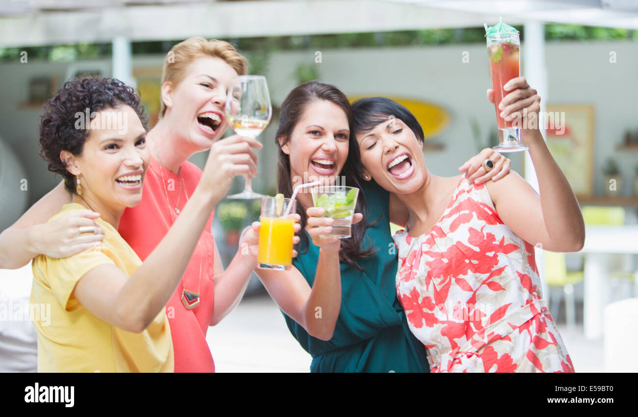 Women cheering together at party Stock Photo