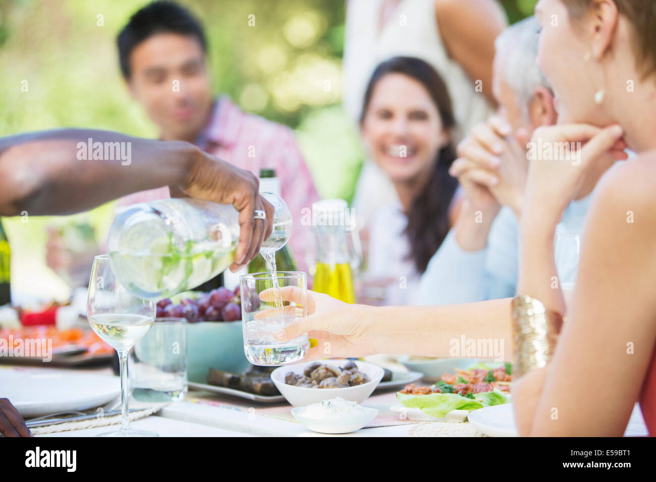 Friends eating together outdoors Stock Photo