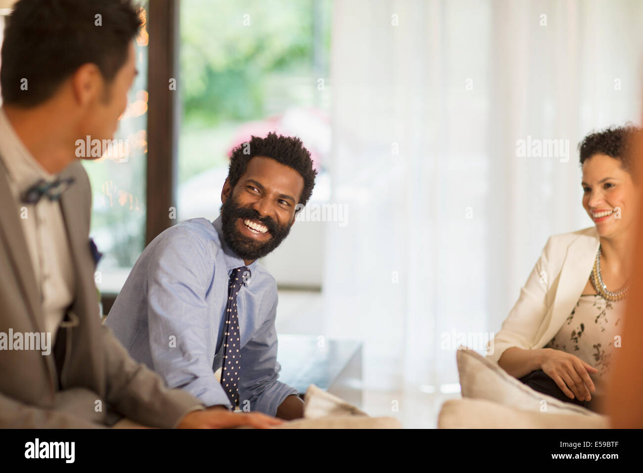 Friends talking at party Stock Photo