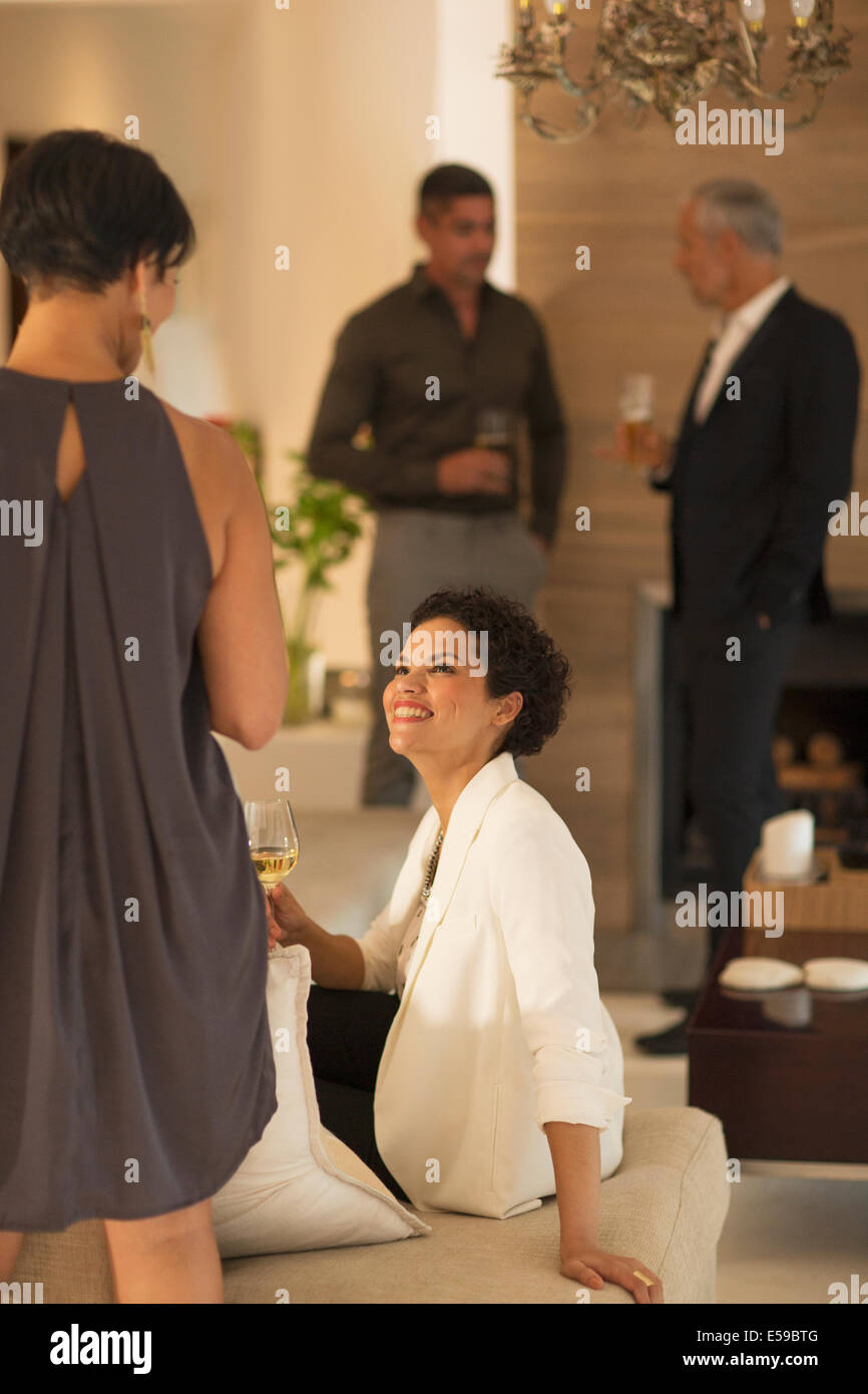 Women talking at party Stock Photo