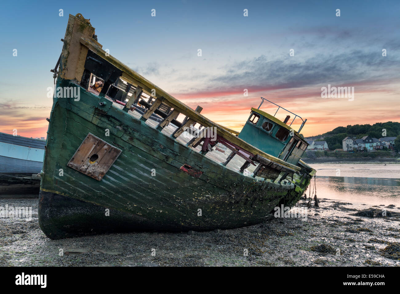 An old wrecked wooden boat on the shore Stock Photo