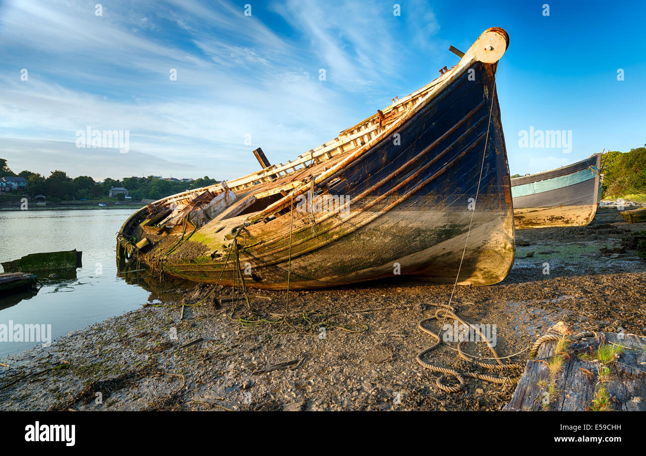 An old wrecked wooden boat on the shore Stock Photo