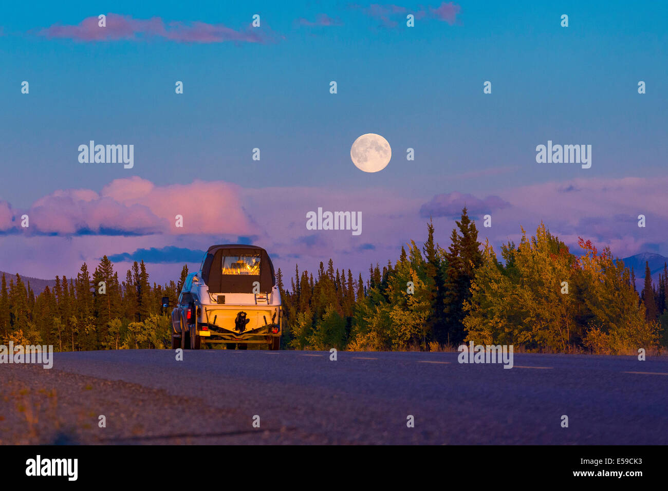 Car on Alaska Highway during full moon, USA Stock Photo