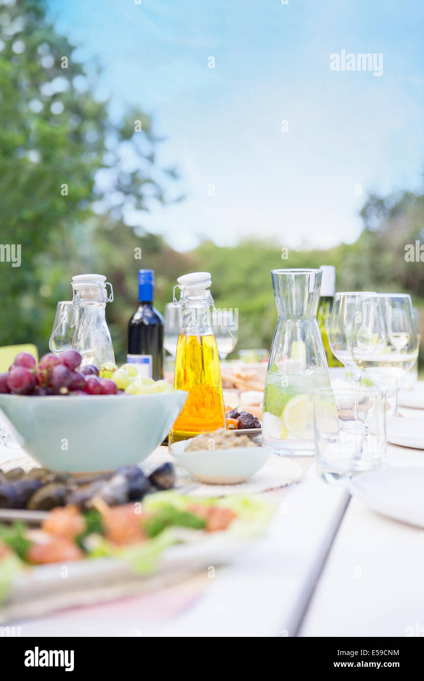 Plates of food on table outdoors Stock Photo