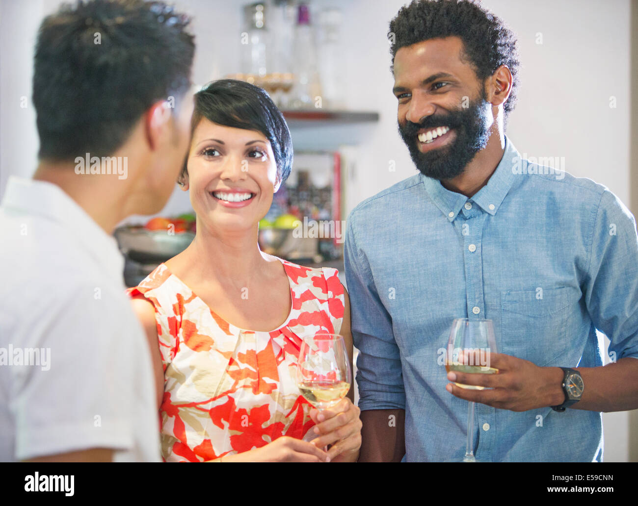 Friends talking at party Stock Photo