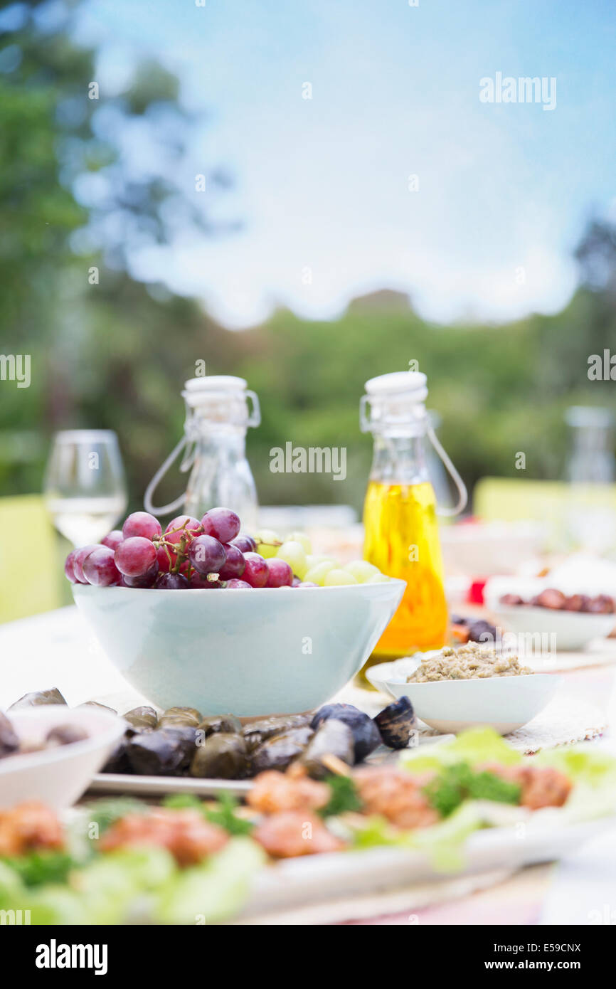 Plates of food on table outdoors Stock Photo