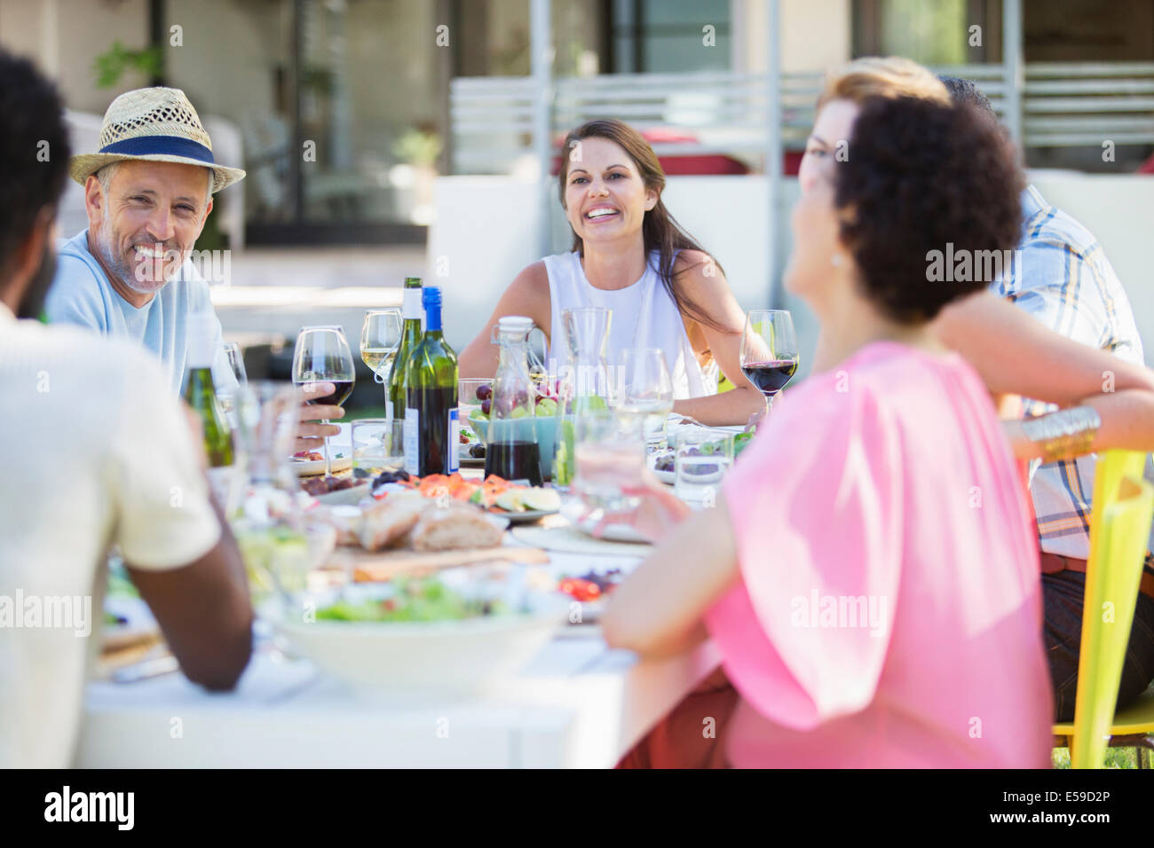 Friends relaxing at table outdoors Stock Photo