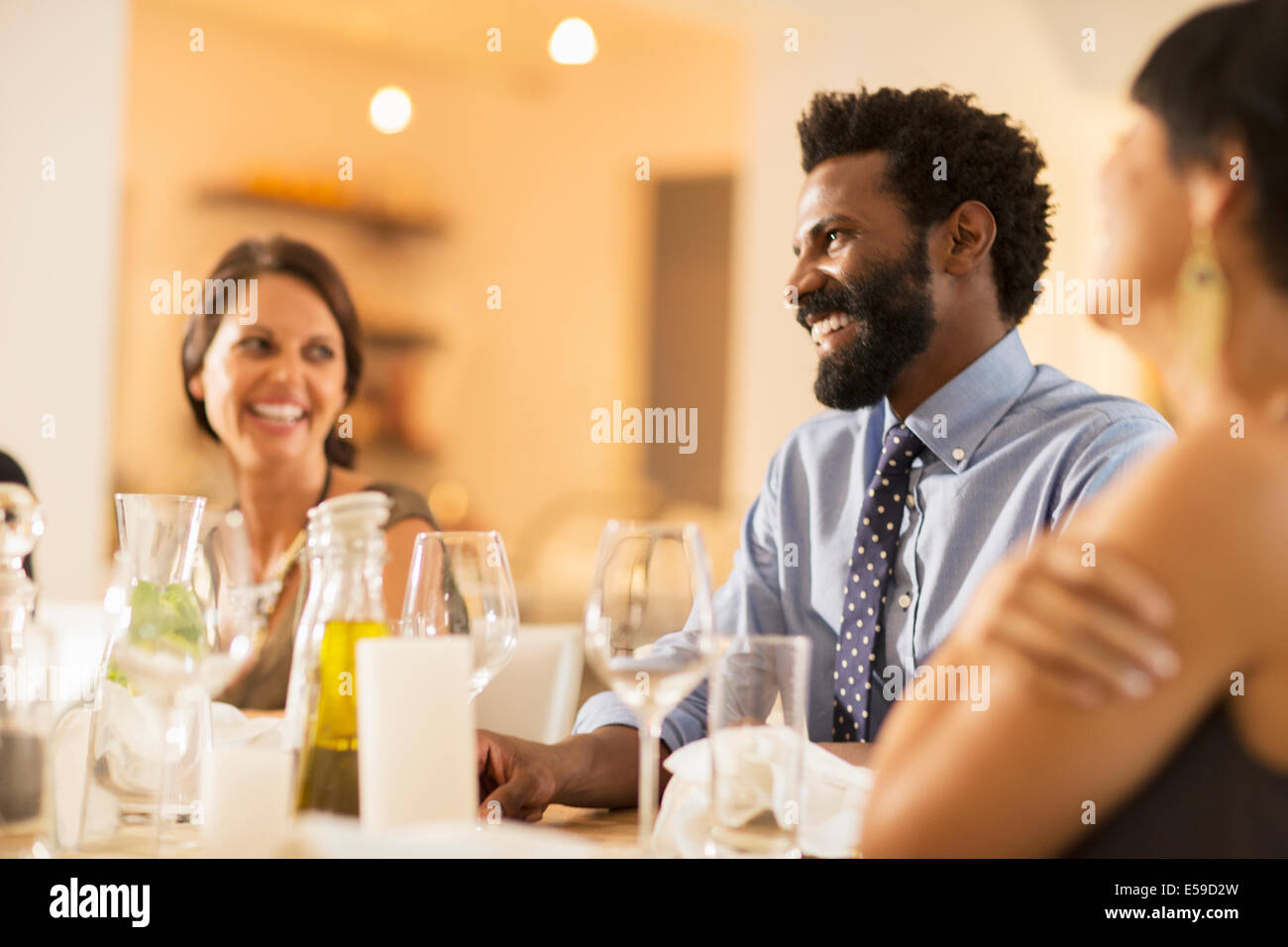 Friends laughing at dinner party Stock Photo