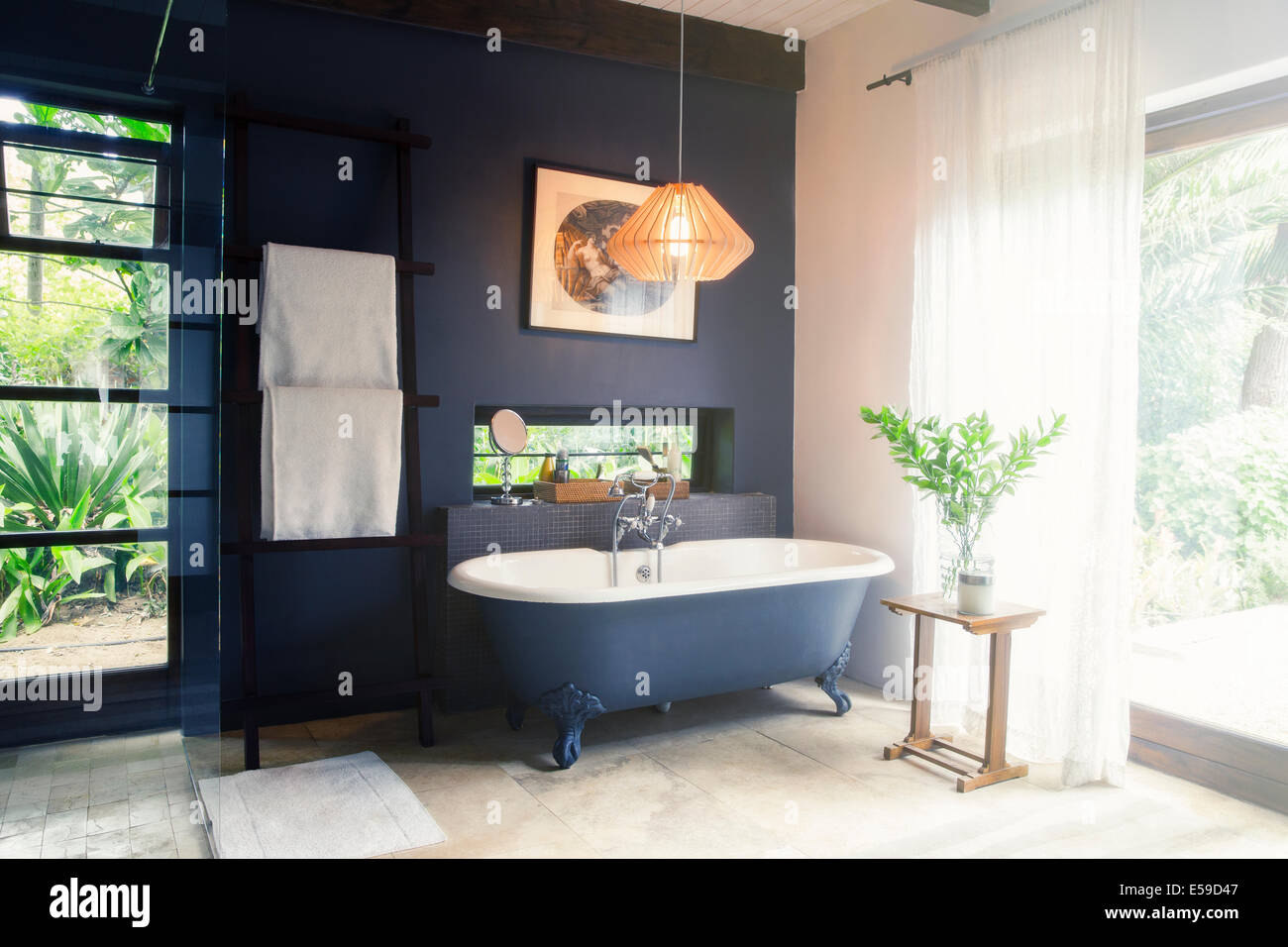 Bathtub and light fixture in modern bathroom Stock Photo