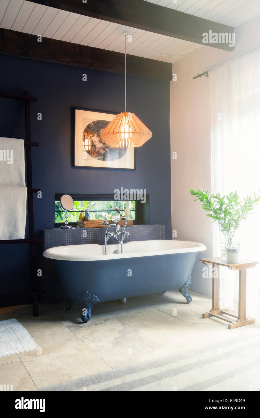 Bathtub and light fixture in modern bathroom Stock Photo Alamy