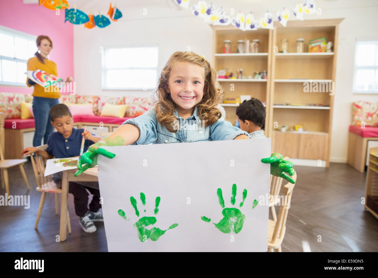 Student holding finger painting in class Stock Photo Alamy