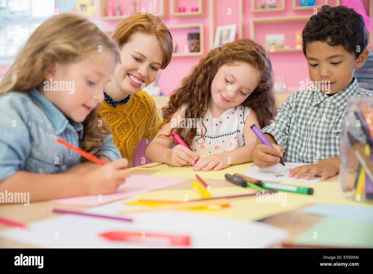 Students and teacher drawing in classroom Stock Photo