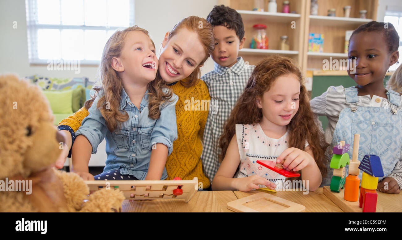 Students and teacher playing in classroom Stock Photo Alamy