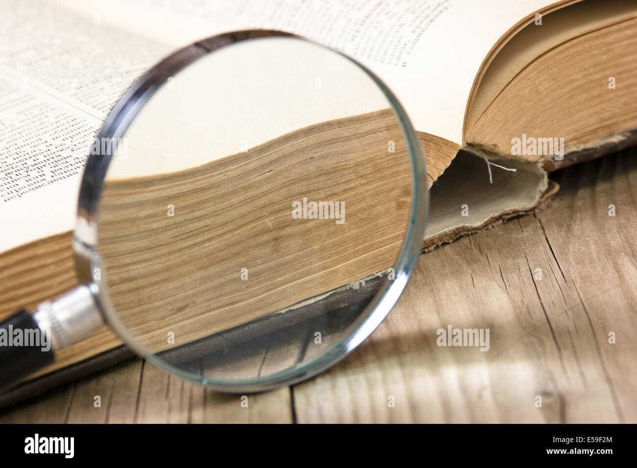 old open book and magnifying glass Stock Photo - Alamy