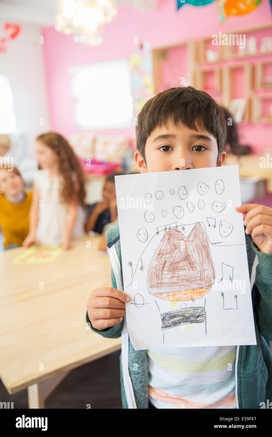 Student showing drawing in classroom Stock Photo